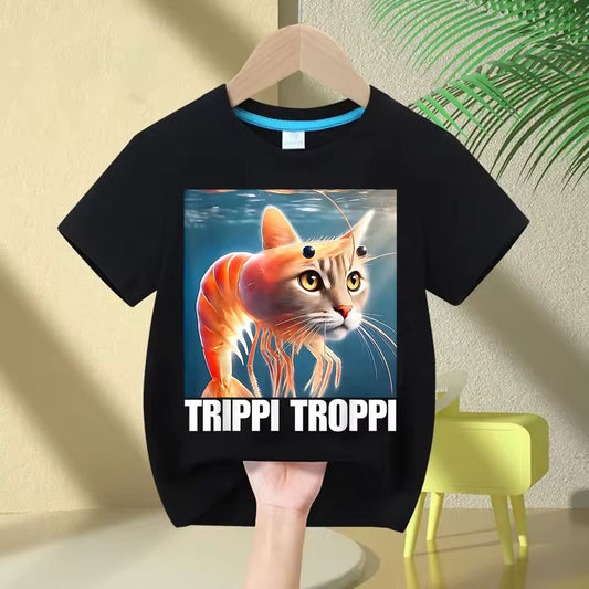 Black t-shirt with a  'TRIPPI TROPHI' on a hanger against a light-colored wall.