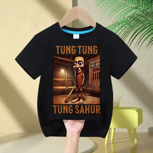 Black t-shirt with a Tung Tung Tung Sahur design and text on a hanger against a light-colored wall.