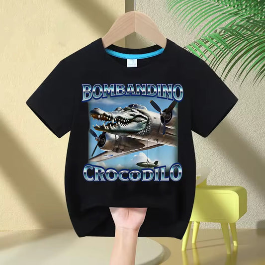 Black t-shirt with Bombandino Crocodilo graphic and text on a hanger against a light-colored wall.